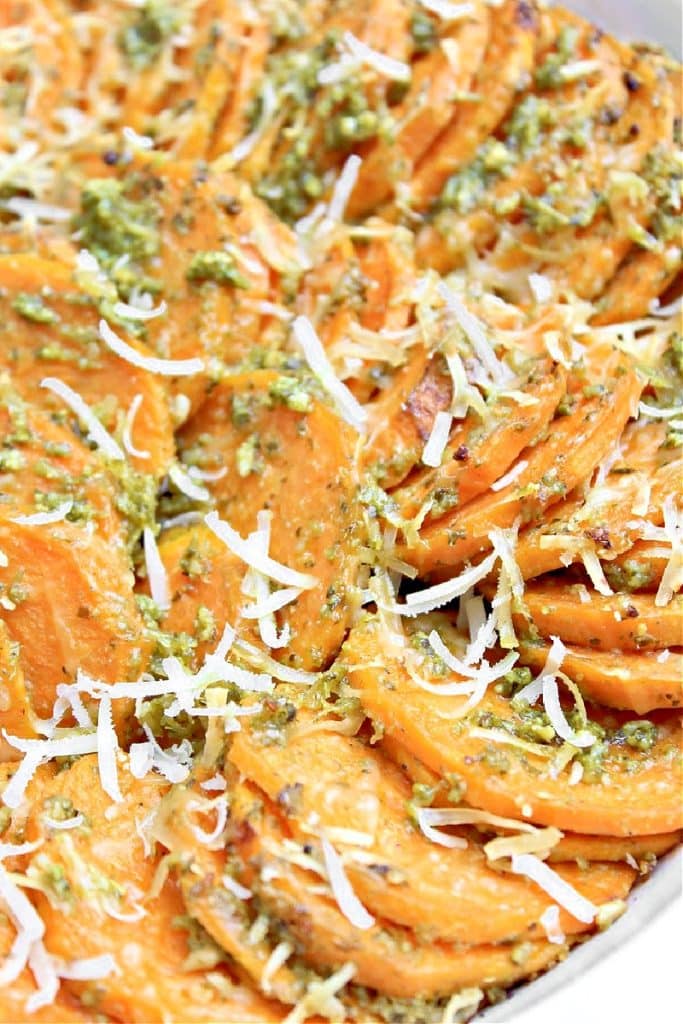 Pesto Sweet Potatoes ~ Thinly sliced sweet potatoes tossed in basil pesto and Parmesan cheese. Perfect for Thanksgiving or Christmas dinner!