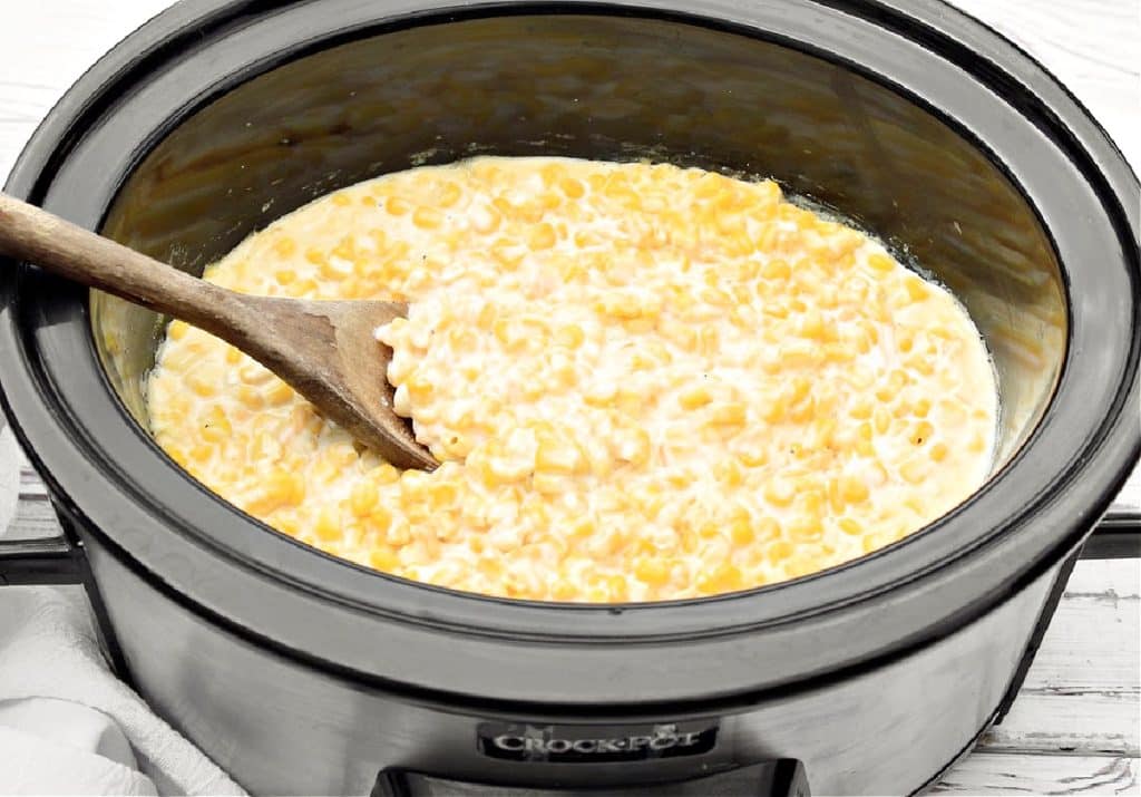 Slow Cooker Cheesy Corn ~ Creamy corn casserole that's always a crowd-pleaser! Ready to serve in 3-4 hours.
