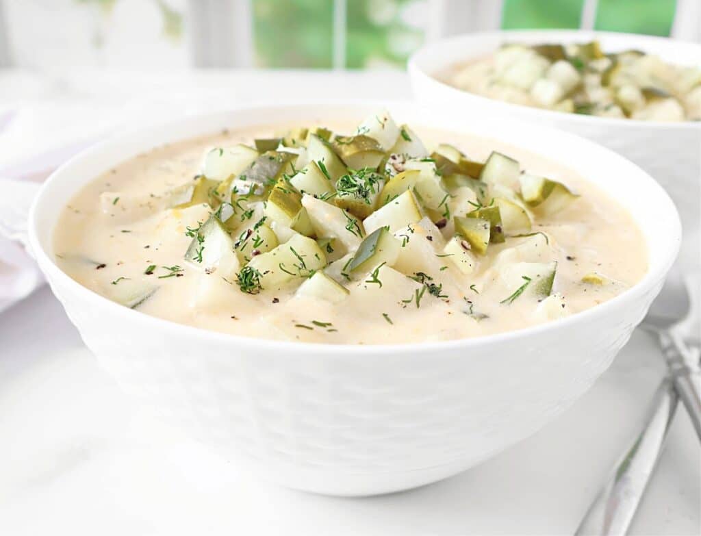 Dill Pickle Potato Soup ~ A cozy blend of creamy potatoes, tangy pickles, and melty cheddar cheese. Ready in 30 minutes or less!
