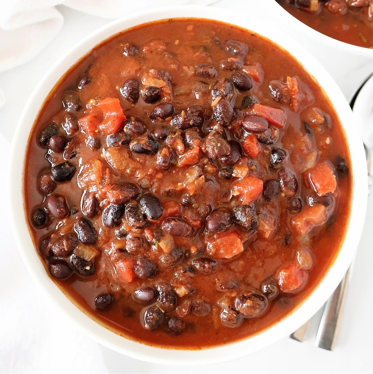 Black Bean Chili ~ A hearty and satisfying plant-based chili ready in 30 minutes or less! Ideal for chilly nights or game day get-togethers.