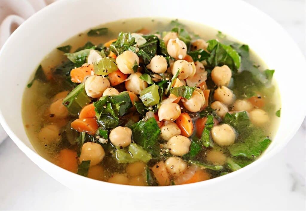 A quick and flavorful soup featuring tender chickpeas, vibrant collard greens, and aromatic spices in a savory broth. Ready in just 20 minutes, it's a wholesome and time-friendly choice for a delicious and comforting meal.