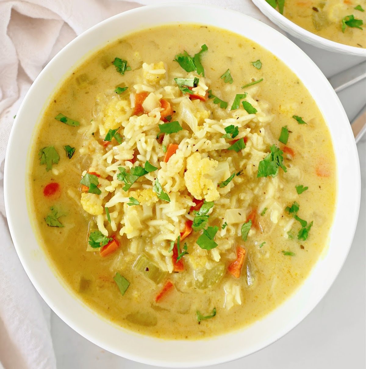 Mulligatawny Soup recipe! Packed with fresh veggies, fragrant rice, and aromatic Indian spices, this hearty dish is quick and easy to make. Serve with naan bread for a complete meal in just 30 minutes. Vegetarian and Vegan.