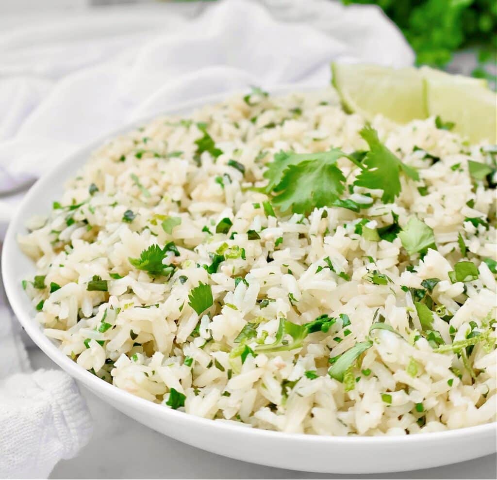 Cilantro Lime Rice ~ Simple and subtle fluffy rice infused with cilantro and lime. Pairs well with Mexican and Indian cuisines.
