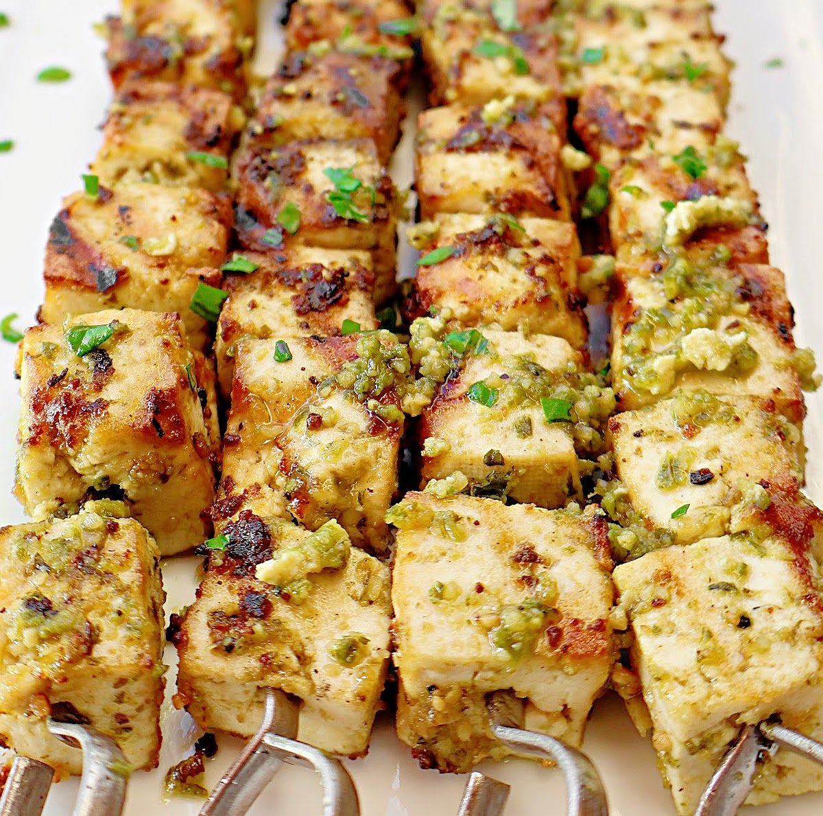 Grilled Pesto Tofu ~ Easy recipe for extra firm tofu marinated in Homemade Basil Pesto and grilled to perfection! Vegetarian and Vegan.