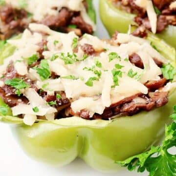 Vegan Cheesesteak Stuffed Peppers ~ Thin sliced vegan steak, sautéed mushrooms and onions, and melted cheese stuffed inside crisp green peppers and roasted to perfection.