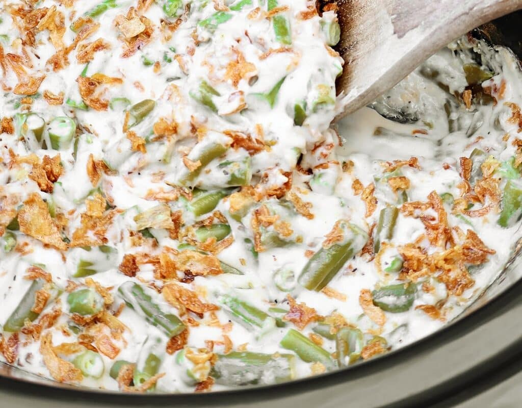 Slow Cooker Green Bean Casserole ~ Tender green beans in a creamy mushroom sauce, topped with crispy fried onions. Easy vegetarian side dish.