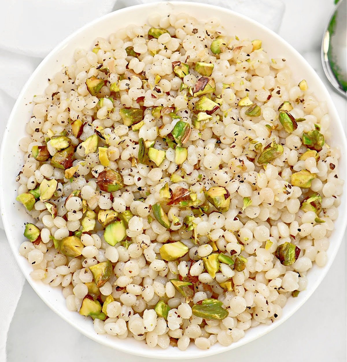 Pistachio Couscous ~ Quick and simple recipe for lightly seasoned pearl couscous studded with crunchy pistachios.