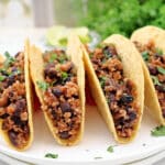 Black Bean Quinoa Tacos ~ Hearty black beans and quinoa cooked with taco spices, lime, and onion, then warmed in crispy shells and ready for your favorite taco toppings. Vegan tacos.