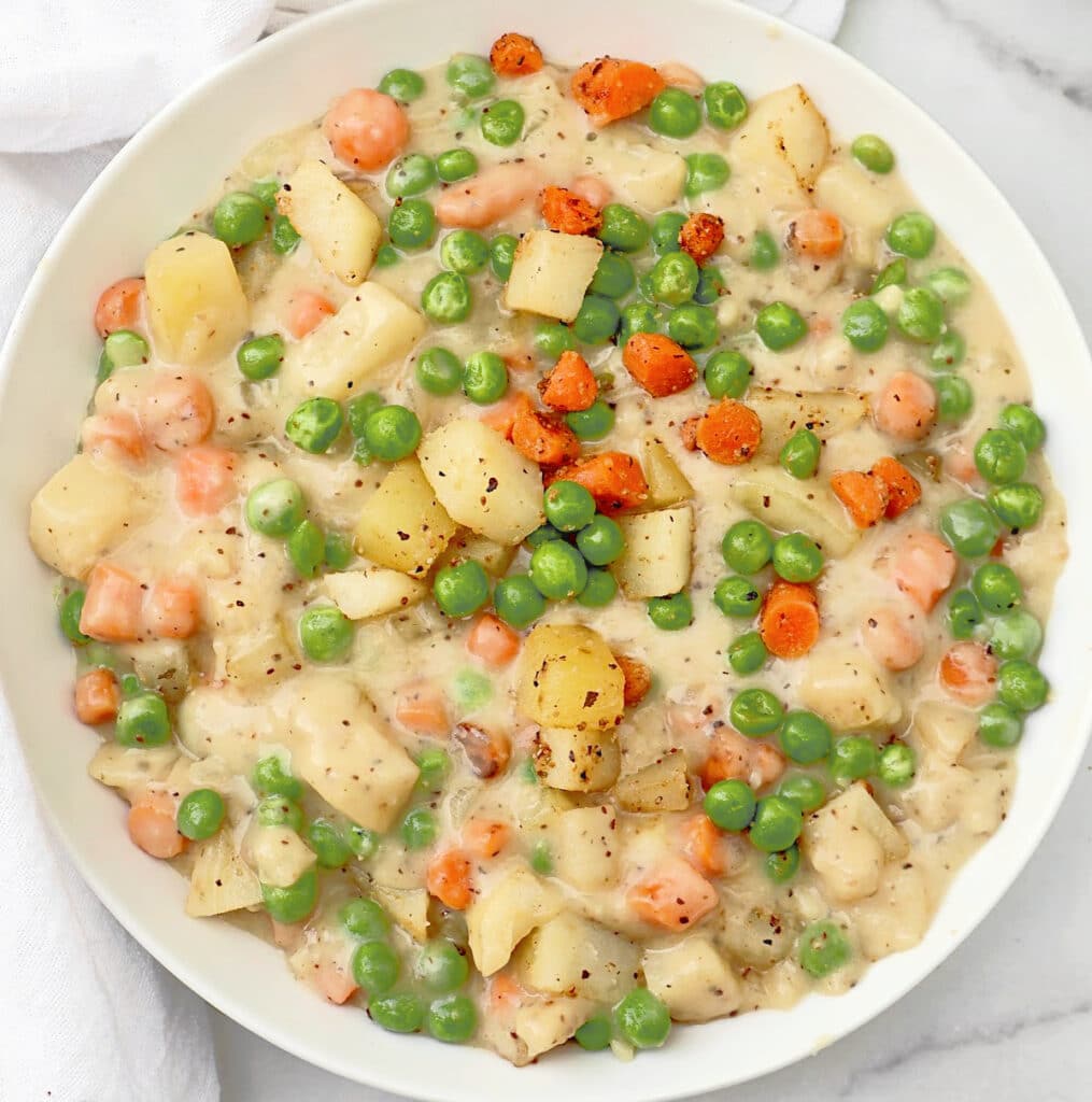 Crustless Veggie Pot Pie ~ All the filling of a classic pot pie with none of the crust! Serve over biscuits for a hearty homestyle dinner.