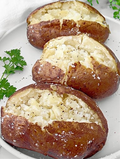 Slow Cooker Baked Potatoes ~ Cooking potatoes in the crockpot is an easy way to make perfectly fluffy and tender baked potatoes every time!