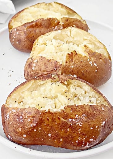 Slow Cooker Baked Potatoes ~ Cooking potatoes in the crockpot is an easy way to make perfectly fluffy and tender baked potatoes every time!