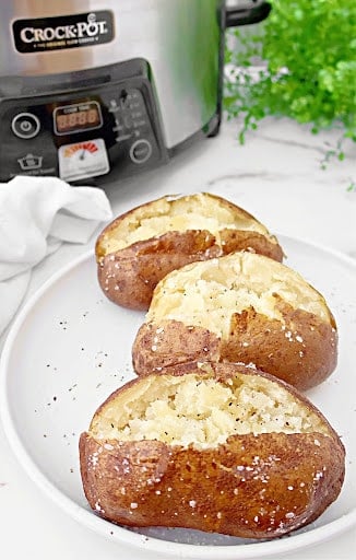 Slow Cooker Baked Potatoes ~ Cooking potatoes in the crockpot is an easy way to make perfectly fluffy and tender baked potatoes every time!