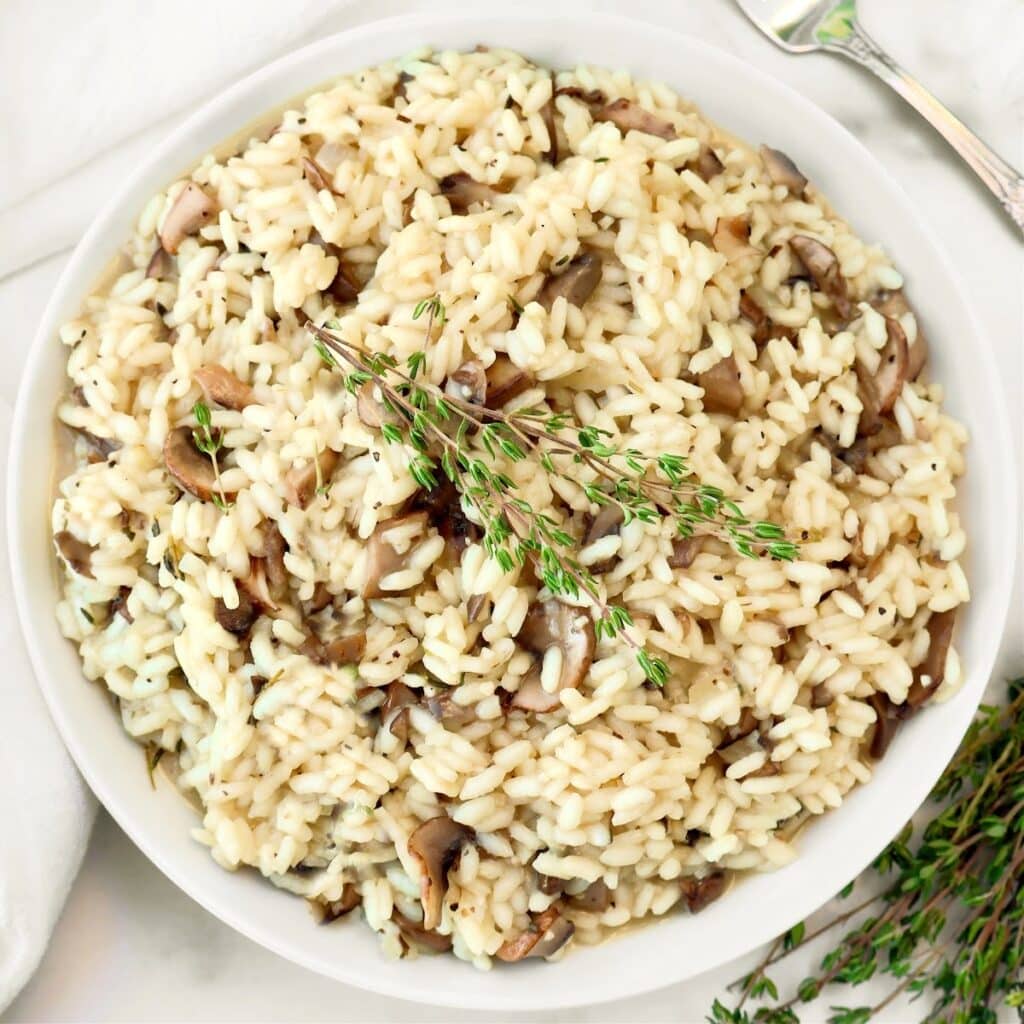 Mushroom Risotto ~ Creamy risotto with the rustic flavors of cremini mushrooms and fresh thyme. Serve as a main course or hearty side dish. Vegetarian or Vegan.