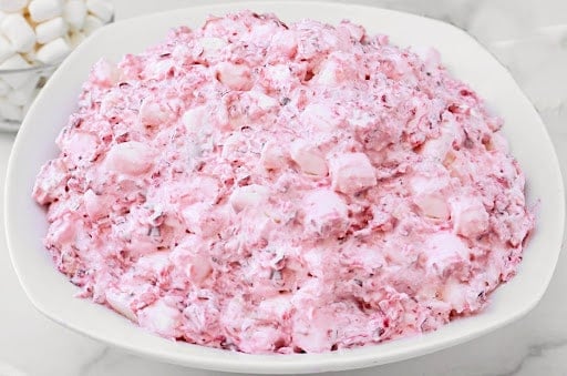 Cranberry Fluff ~ A fluffy blend of tart cranberries, sweet marshmallows, and pineapple that sneaks onto the table as “salad.”