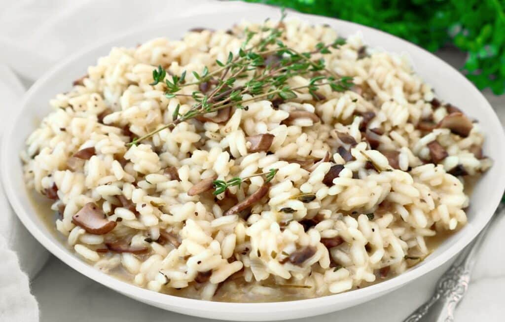 Mushroom Risotto ~ Creamy risotto with the rustic flavors of cremini mushrooms and fresh thyme. Serve as a main course or hearty side dish. Vegetarian or Vegan.