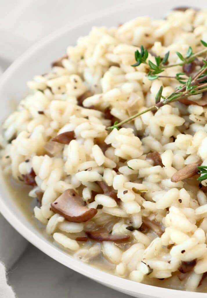 Mushroom Risotto ~ Creamy risotto with the rustic flavors of cremini mushrooms and fresh thyme. Serve as a main course or hearty side dish. Vegetarian or Vegan.