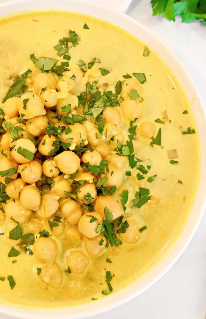 Chickpea Curry Soup ~ Protein-packed chickpeas (garbanzo beans) and warm spices in a comforting soup. Ready in 20 minutes. Vegetarian and Vegan.