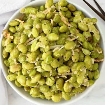 Roasted Edamame with Parmesan ~ Edamame beans coated in a savory blend of Parmesan, garlic, and olive oil, then roasted to perfection.