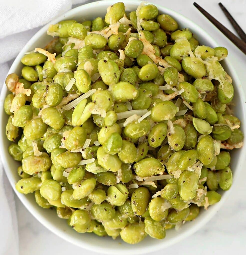 Roasted Edamame with Parmesan ~ Edamame beans coated in a savory blend of Parmesan, garlic, and olive oil, then roasted to perfection.