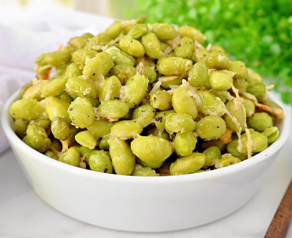 Roasted Edamame with Parmesan ~ Edamame beans coated in a savory blend of Parmesan, garlic, and olive oil, then roasted to perfection.