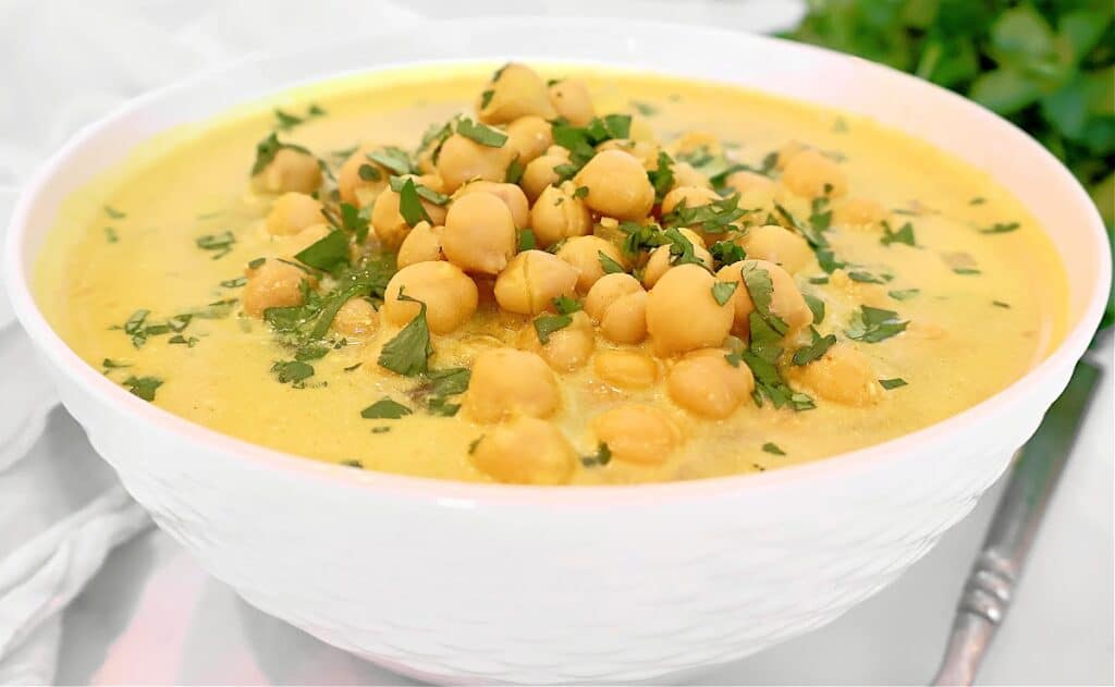 Chickpea Curry Soup ~ Protein-packed chickpeas (garbanzo beans) and warm spices in a comforting soup. Ready in 20 minutes. Vegetarian and Vegan.