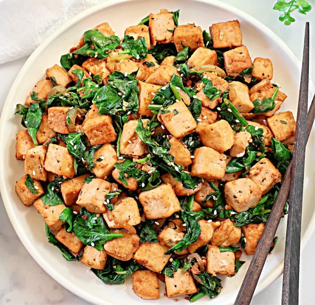 Spinach and Tofu Stir Fry ~ Savory, plant-based stir-fry featuring crisp tofu, sauteed onions, garlic, ginger, and fresh spinach.