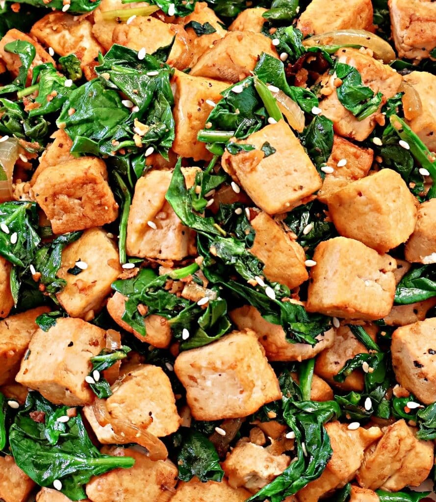 Spinach and Tofu Stir Fry ~ Savory, plant-based stir-fry featuring crisp tofu, sauteed onions, garlic, ginger, and fresh spinach.