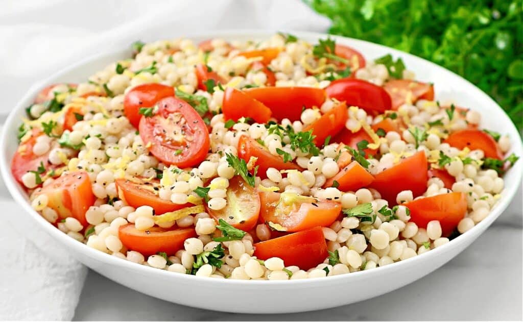 Tomato Couscous ~ Lemony pearl (Israeli) couscous with juicy tomatoes and fresh parsley. Ready in 20 minutes! Vegetarian & Vegan recipe.