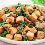 Spinach and Tofu Stir Fry ~ Savory, plant-based stir-fry featuring crisp tofu, sauteed onions, garlic, ginger, and fresh spinach.