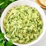 Cilantro Lime Guacamole Dip Recipe - Ripe avocados, fresh cilantro, onion, simple seasonings, and lime juice combine to create authentic guacamole in minutes.