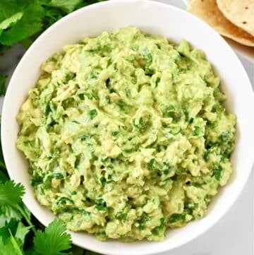 Cilantro Lime Guacamole Dip Recipe - Ripe avocados, fresh cilantro, onion, simple seasonings, and lime juice combine to create authentic guacamole in minutes.