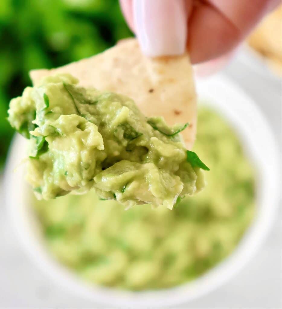 Cilantro Lime Guacamole Dip Recipe - Ripe avocados, fresh cilantro, onion, simple seasonings, and lime juice combine to create authentic guacamole in minutes.