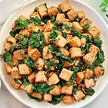 Spinach and Tofu Stir Fry ~ Savory, plant-based stir-fry featuring crisp tofu, sauteed onions, garlic, ginger, and fresh spinach.