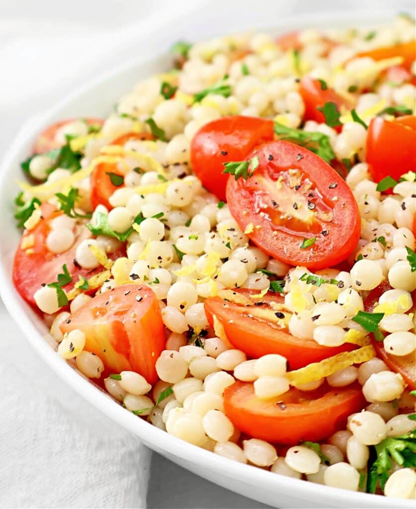 Tomato Couscous ~ Lemony pearl (Israeli) couscous with juicy tomatoes and fresh parsley. Ready in 20 minutes! Vegetarian & Vegan recipe.