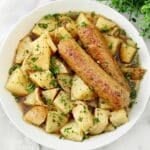 A bowl of Dublin Coddle, a hearty Irish stew made with plant-based sausages, potatoes, and a rich, savory Guinness broth.