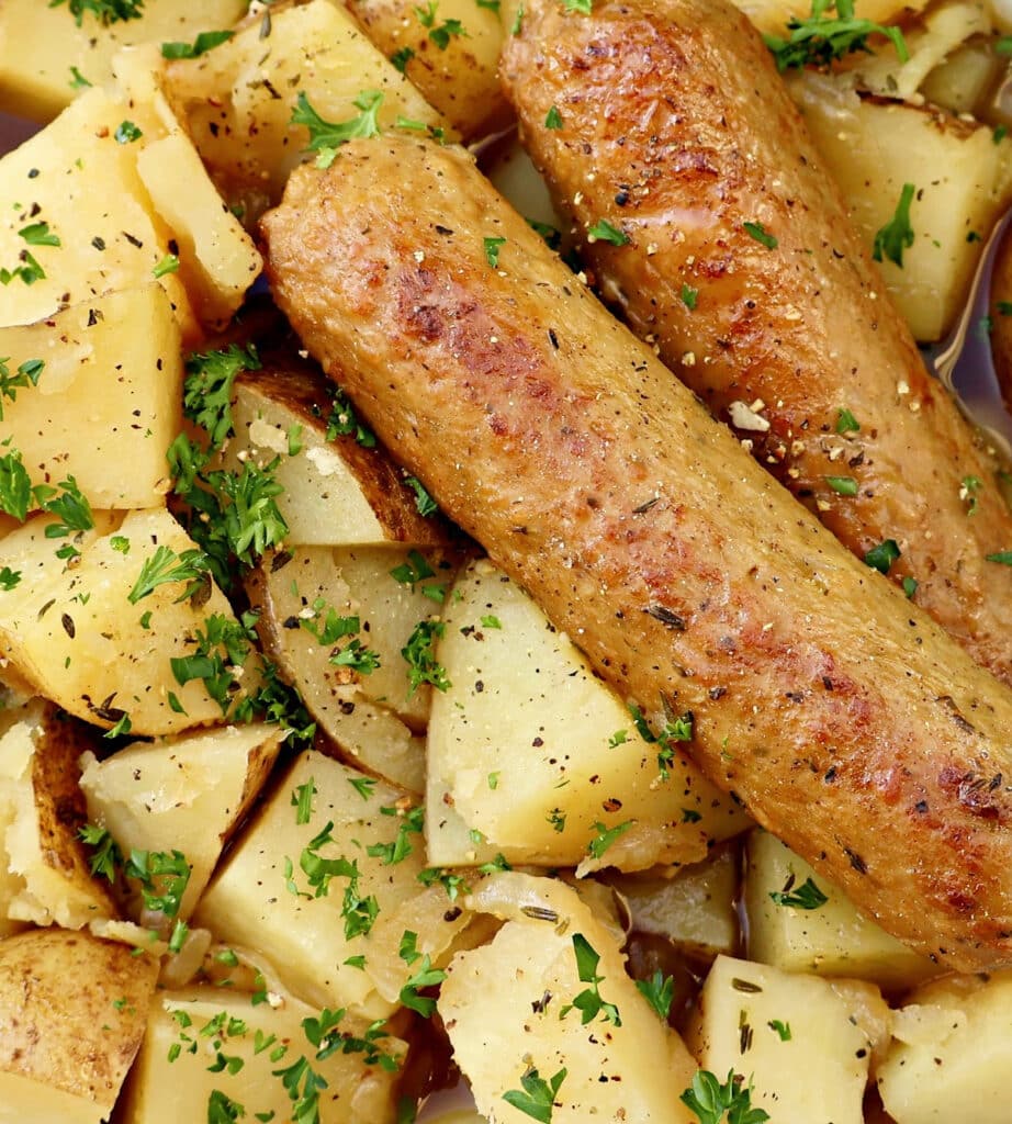 A bowl of Dublin Coddle, a hearty Irish stew made with plant-based sausages, potatoes, and a rich, savory Guinness broth.