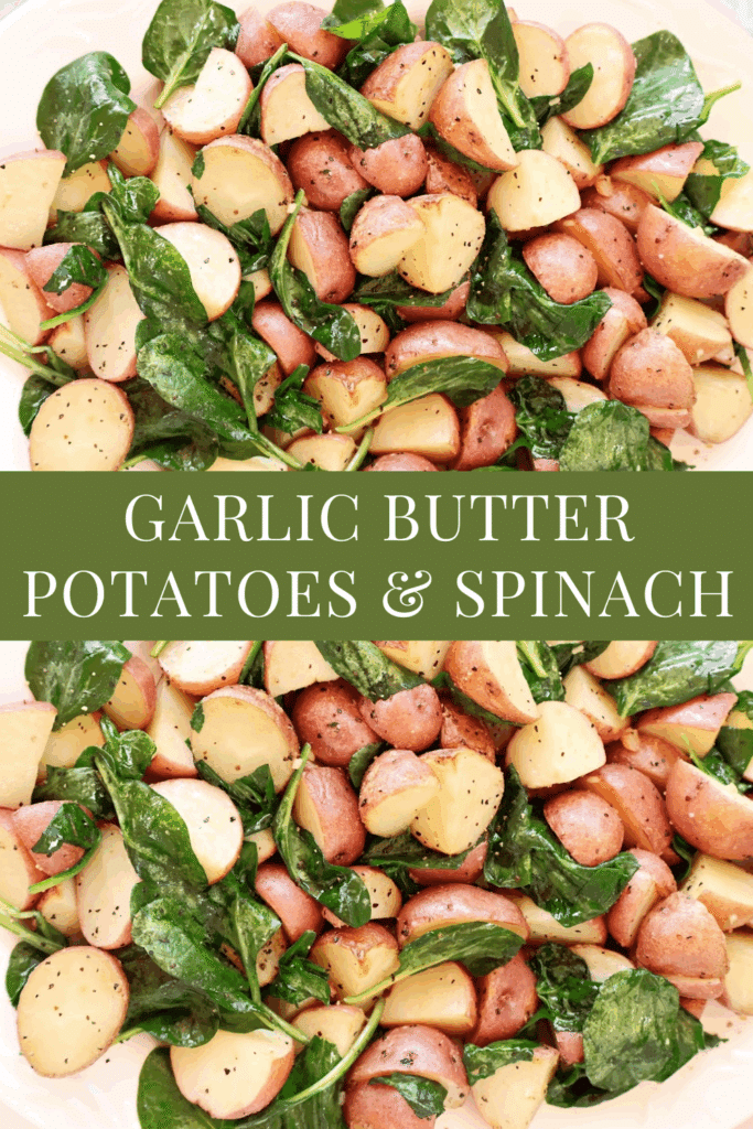 A close-up of roasted red potatoes and fresh spinach leaves, seasoned with herbs and black pepper, arranged on a white plate with the text GARLIC BUTTER POTATOES & SPINACH in the center.