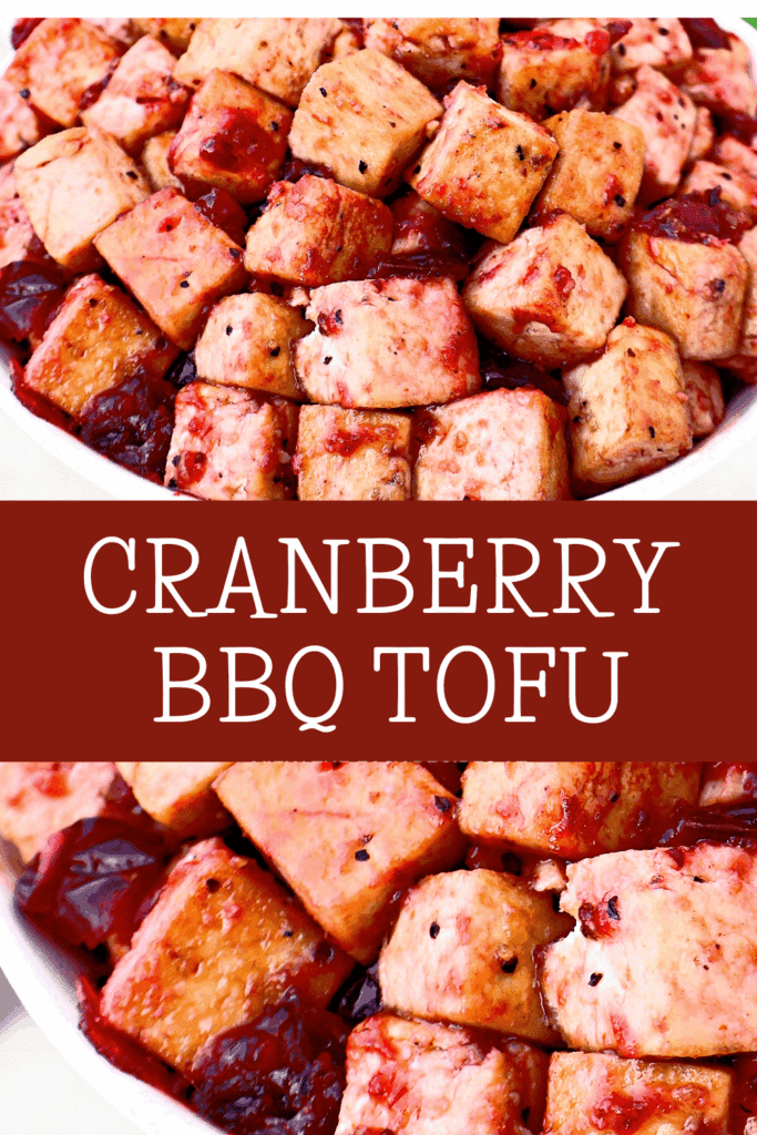 A bowl filled with golden-brown tofu cubes coated in a cranberry BBQ sauce, with visible bits of cranberry, shown up close above and below the text “CRANBERRY BBQ TOFU” on a maroon background.